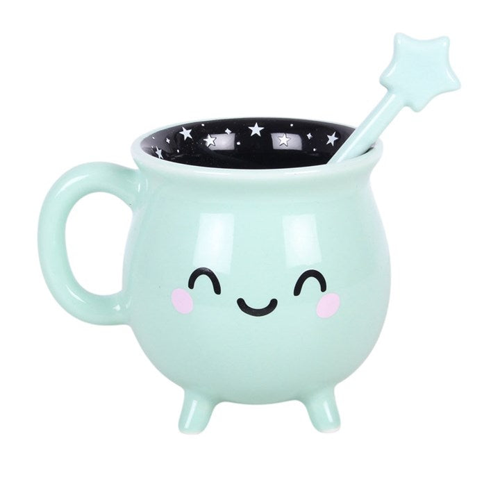 Tasse en forme de chaudron vert menthe avec une baguette pour remuer