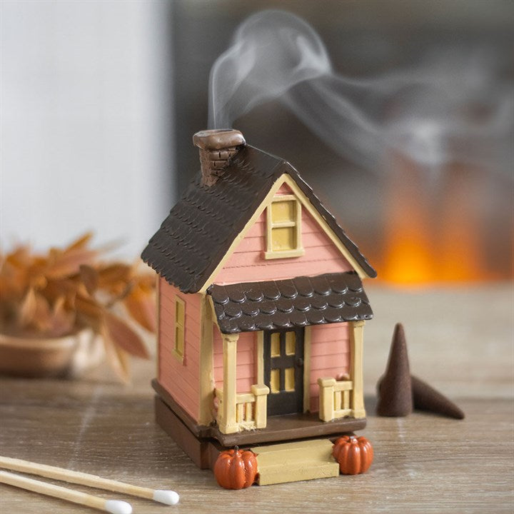 Brûleur d'encens en forme de maison rose avec des citrouilles