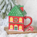 Tasse rouge à couvercle de la maison de Noël
